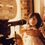 Zooey Deschanel as a child with her father on set